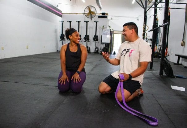 Coach assisting a woman